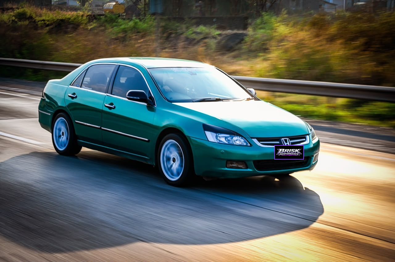 Green Honda Accord driving on the highway